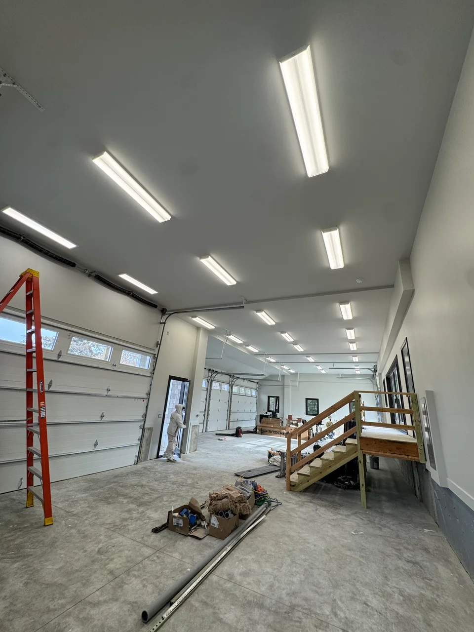 The same interior after preparation and painting, with painted walls and ceiling and other construction still in progress